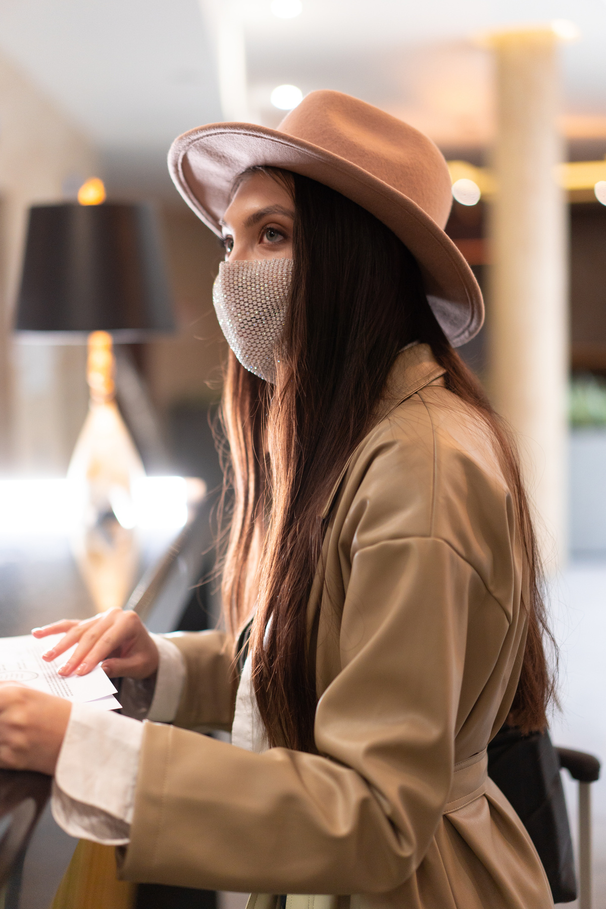 Shallow Focus Photo of Woman in Brown Coat and Fedora Hat